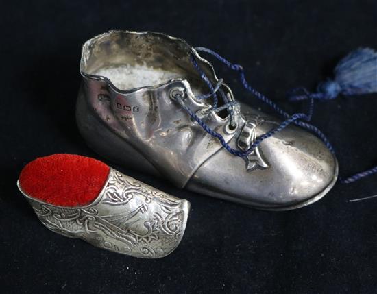 An Edwardian silver shoe pin cushion, Levi & Salaman, Birmingham, 1906, (lacking cushion) and a later silver shoe pin cushion.